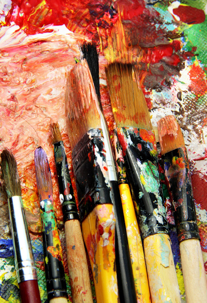 Beautiful vivid art palette and mix of paintbrushes - Photo, Image