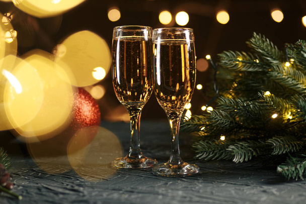 Ribbon, baubles and wine against Christmas lights - Фото, зображення