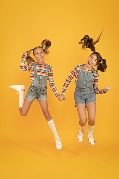 Emotional kids. Fashion shop. Must have accessory. Modern fashion. Kids fashion. Girls long hair. Cute children same outfits. Trendy and fancy. Little girls wearing rainbow clothes. Happiness - Photo, image