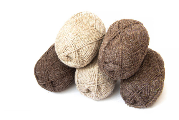 Wool yarns for knitting. Wool thread for knitting. Own hand. Knitting and needlework. Yarns for a scarf, sweater, and socks. Balls of yarn. Article about earning money at home with your hands. Article about knitting. Leisure for pensioners - Photo, Image