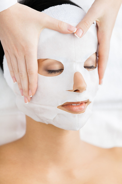 Hands of therapist apply mask to woman face - Photo, Image