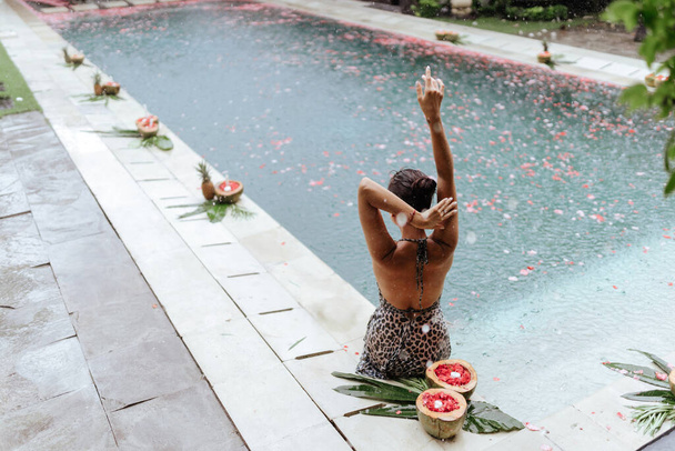 Happy beautiful woman in pool in Bali - Photo, Image