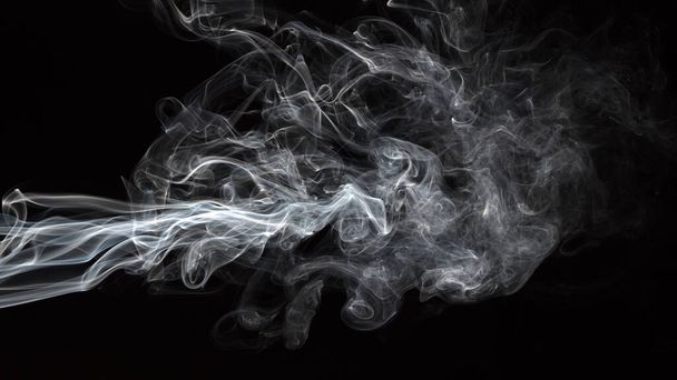 Smoke isolated on black background. Movement of white smoke - Фото, изображение