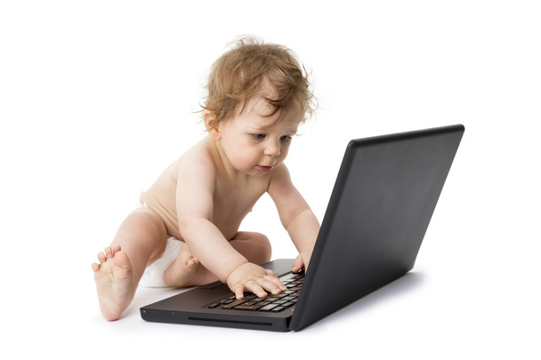 Ребенок играет с ноутбуком
 - Фото, изображение