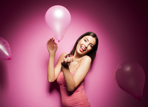 Beautiful woman with valentines day decorations on pink background - Fotó, kép