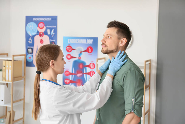 Arzt untersucht Mann mit Schilddrüsenproblem in Klinik - Foto, Bild