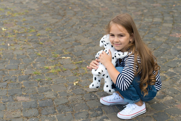 Youre my friend. Small girl play with toy dog outdoors. Little child enjoy friendship. Childhood friendship. Developing communication skills. International friendship day. Love and trust, copy space - 写真・画像