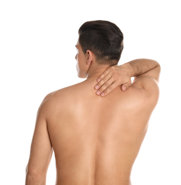 Man suffering from pain in neck on white background. Visiting orthopedist - Φωτογραφία, εικόνα