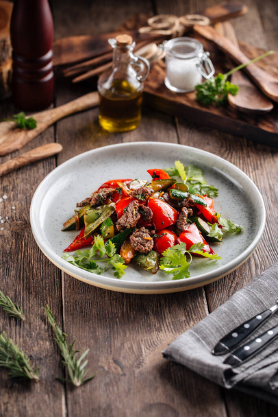 Warm salad with beef and vegetables on a plate - Photo, Image