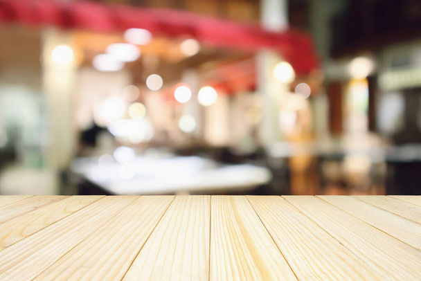 Wood table with Restaurant cafe or coffee shop interior with people abstract defocused blur background - Photo, Image