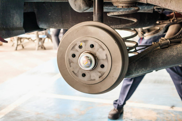 tyre replacement service, Car brake without wheels at auto repair shop - Photo, Image