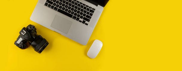 Photographer's equipment.Flat lay composition with photographer's equipment and laptop on yellow background.Photographer's workplace on a yellow background.Copy space - 写真・画像