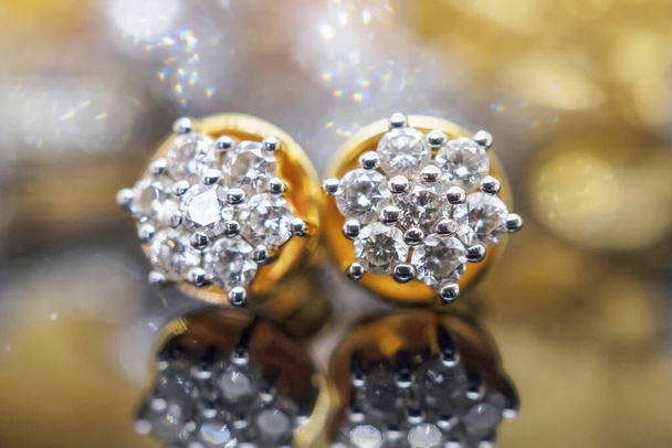 Luxury gold Jewelry diamond earrings with reflection on black background - Photo, Image