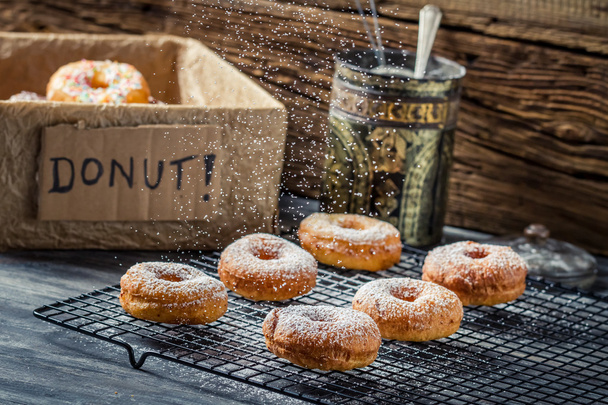Icing sugar falling on fresh donuts - Foto, Imagem