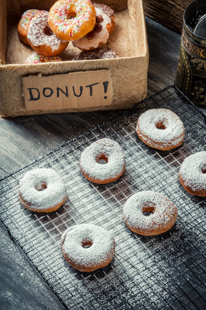 Freshly decorated with powdered sugar donuts - Фото, изображение