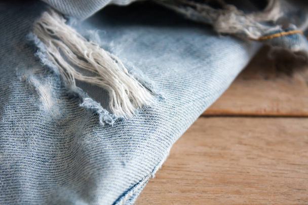 Close up of blue jeans ,Blue Jeans texture on wooden floor - Foto, imagen