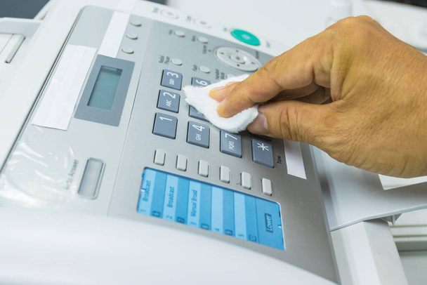 Concept Prevention cleaning frequently, Focus on the high traffic areas that enable pathogens to spread around the Number button of fax machine in office - Photo, Image