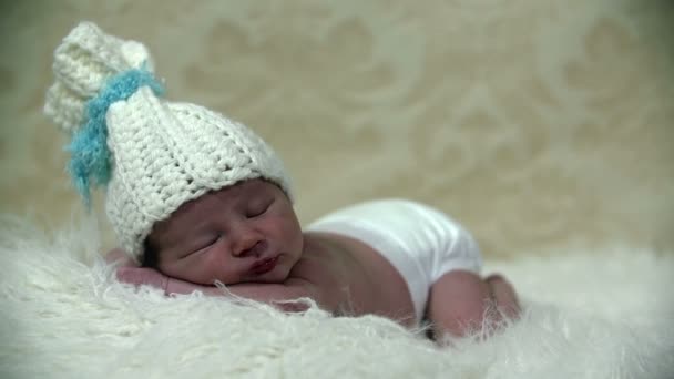 Baby boy with white cap sleeping firmly - Footage, Video