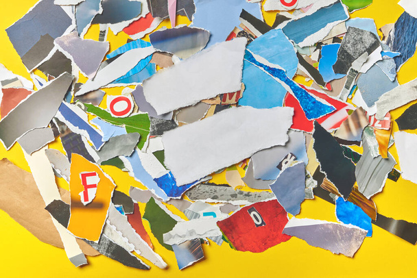 Paper scrap collage top view as background, Overhead shot of torn pieces of magazine paper as texture. - 写真・画像