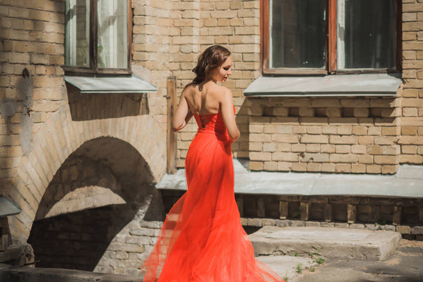 Evening dresses concept, elegant fancy style. Woman in evening red dress. Clothes for ladies, inspiration  - 写真・画像