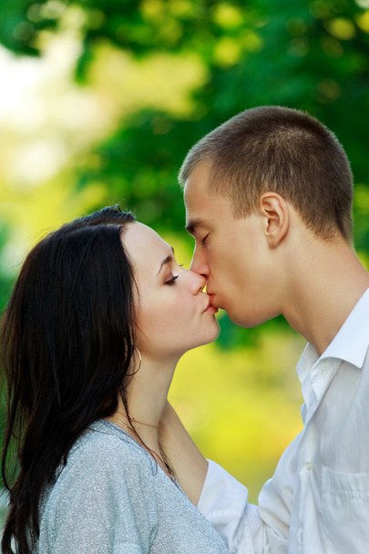 Kissing couple in the park - Фото, зображення