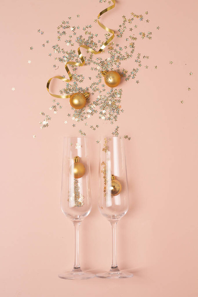 glasses and sparkles christmas concept on pink backgroun - Photo, Image