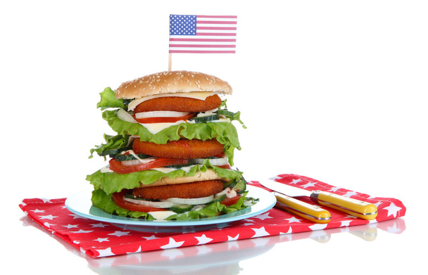 Composition with huge burger on color plate and USA flag, isolated on white - Zdjęcie, obraz
