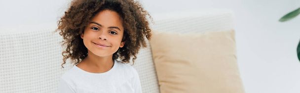 horizontal image of curly african american child looking at camera - Photo, Image