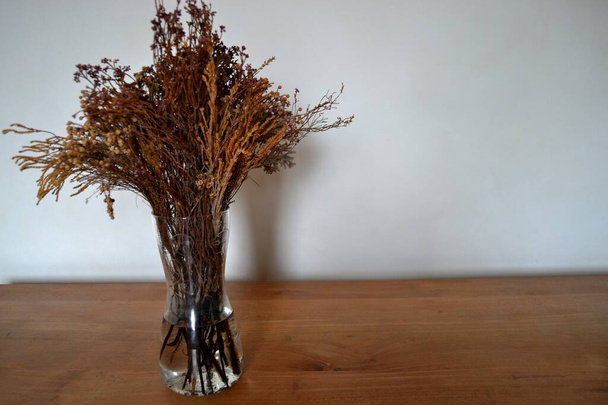Dried flowers on wooden table - Foto, imagen