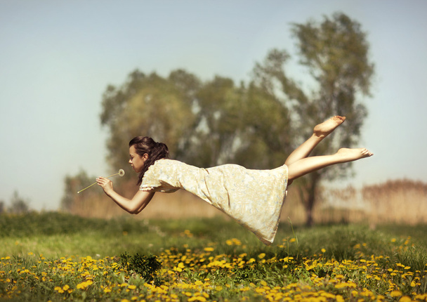 Girl flies over a field. - Photo, Image