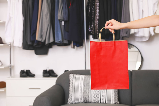 Woman with shopping bag in modern clothes store - Foto, Imagen