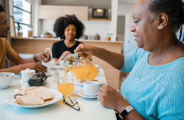 Portrait of African american family having breakfast together at home. Family and lifestyle concept. - Photo, Image