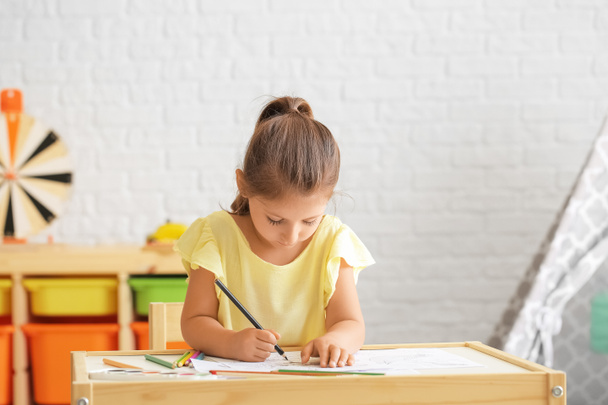 Cute little girl coloring pictures at home - Photo, Image