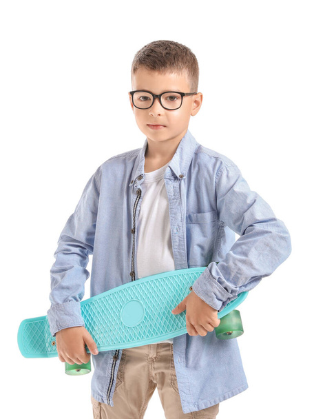 Cute little boy with skateboard on white background - Fotoğraf, Görsel