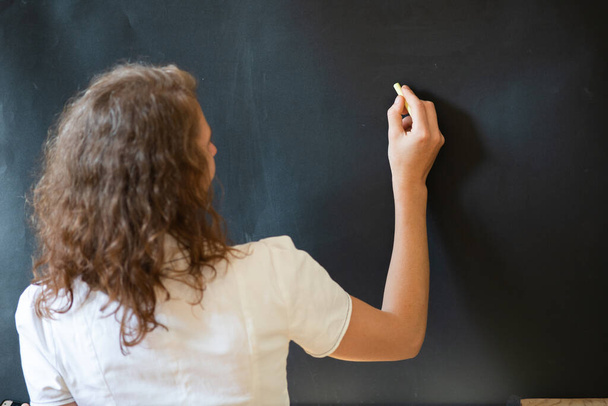 back to school concept teacher in front of chalkboard - Foto, afbeelding
