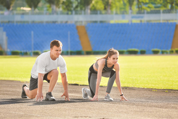 Sporty young couple training in the stadium - Foto, Imagem
