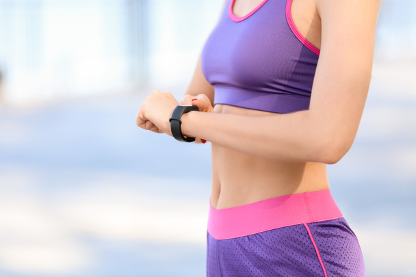 Sporty young woman with fitness tracker outdoors, closeup - Φωτογραφία, εικόνα