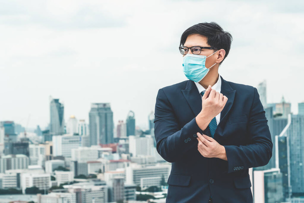Young office worker with face mask quarantine from coronavirus or COVID-19. Concept of protective working environment to reopen business and stop spreading of coronavirus or COVID-19. - Photo, Image