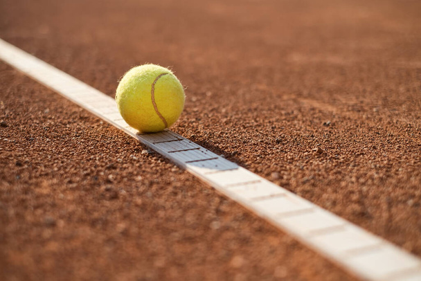 Tennis ball on the court. Sports equipment for active lifestyle. Ball and court as a background. - Fotografie, Obrázek