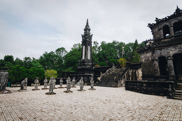 The Khai Dinh Royal Tomb complex forecourt featuring the statues of honor guards in formation and the octagonal stele pavilion - Photo, Image