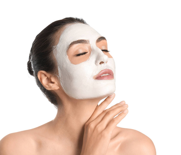 Beautiful young woman with mask on her face against white background - Photo, Image