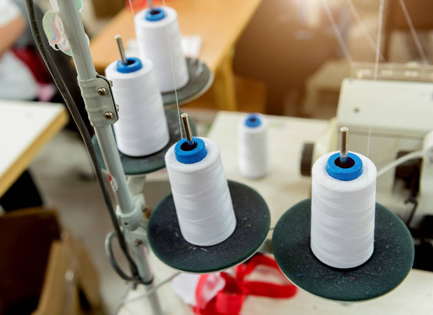 Fabric industry production line. Textile factory. Working tailoring process - 写真・画像