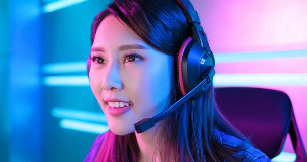 Young asian pro gamer girl wear on headphones and ready to play in online video game - Фото, зображення