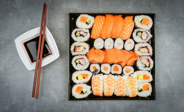 Japanese sushi food. Maki ands rolls with tuna, salmon, shrimp, crab and avocado.  assorted sushi - Photo, image
