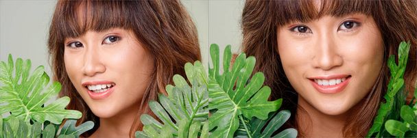 顔の頭のショット20代のアジアの女性の肖像画日焼けした肌茶色のブロンドの髪のスタイル化粧品を構成します。女の子エクスプレス感とホールド緑の葉以上グレー背景孤立 - 写真・画像