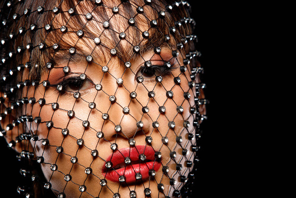 Face shot Portrait of 20s Asian Woman tanned skin Cosmetic Make up. Girl decorate diamond Crystal Net cover head over dark Background isolated, close up look Fashion - Photo, Image
