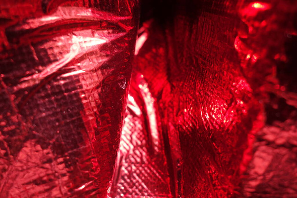 Vymaštěná plastová červená polyetylenová fólie - Fotografie, Obrázek