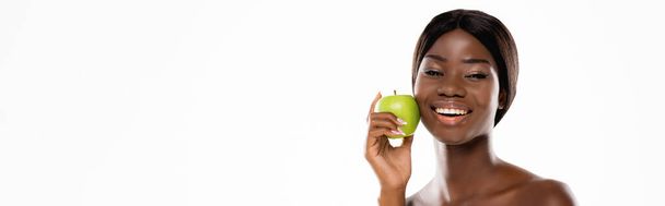 naked african american woman holding green ripe apple isolated on white, panoramic shot - Photo, Image
