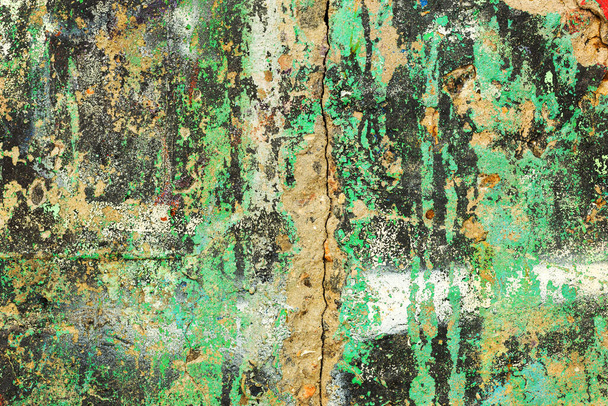 Abstract creative background of chaotic strokes of old cracked paint on concrete wall. Old surface with traces of paint, weathered, scratches and cracks for design - Фото, зображення