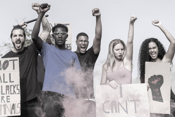 Malá aktivistická skupina, která jde proti policii a háže slzný plyn. Multietničtí lidé bojující za lidská práva. Žádný rasismus. - Fotografie, Obrázek